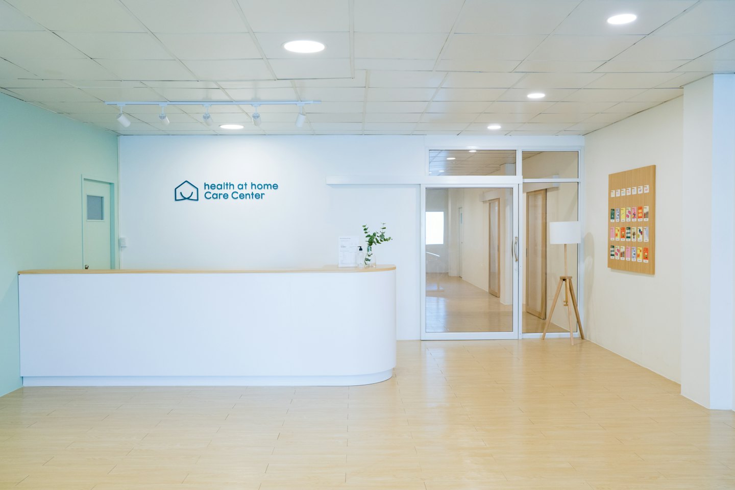 Modern reception desk in a clean healthcare facility hallway.