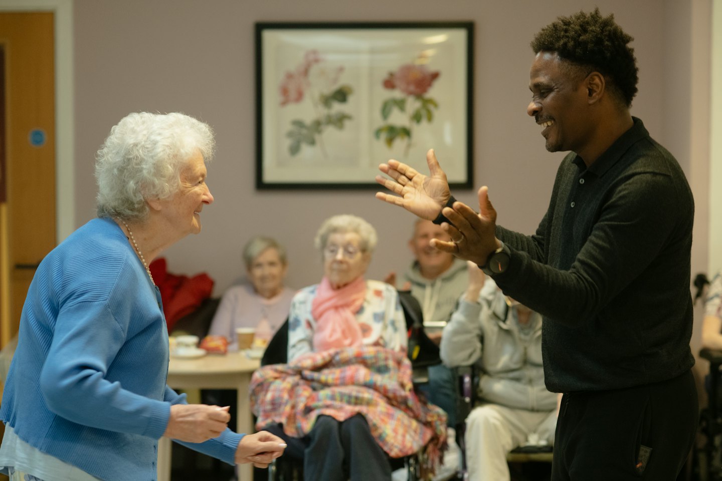 Older adults interacting cheerfully in a community center.